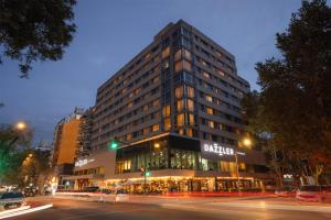 a large building on a city street at night at Dazzler by Wyndham Montevideo in Montevideo