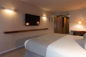 Ein Bett oder Betten in einem Zimmer der Unterkunft Dazzler by Wyndham Montevideo