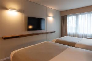 Ein Bett oder Betten in einem Zimmer der Unterkunft Dazzler by Wyndham Montevideo
