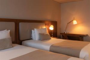 Ein Bett oder Betten in einem Zimmer der Unterkunft Dazzler by Wyndham Montevideo