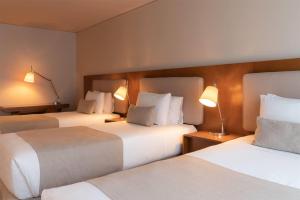 Ein Bett oder Betten in einem Zimmer der Unterkunft Dazzler by Wyndham Montevideo