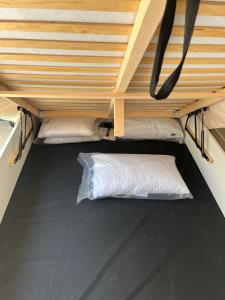 a bunk bed with a pillow in the bottom bunk at Chambre et salle de bain dans dépendance in Marseille