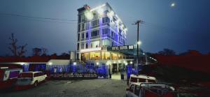 a building with blue lights on the side of it at Hotel Surya Inn in Kānsrao