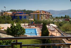 a view of a resort with a swimming pool at Apartamentos Esperanza del Mar in Portonovo