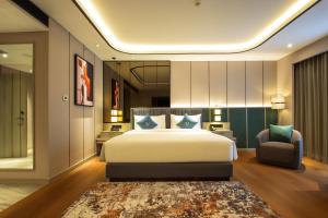 Postel nebo postele na pokoji v ubytování FUGO Hotel Banjarmasin
