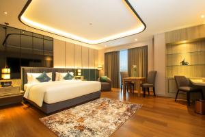 Postel nebo postele na pokoji v ubytování FUGO Hotel Banjarmasin