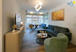 a living room with a couch and a table at Haus Casper Ferienwohnung 3 in Langeoog