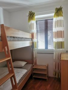a bedroom with bunk beds and a window at Istrian old town apartment in Koper