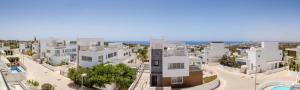 une vue aérienne sur une ville avec des bâtiments blancs dans l'établissement Elite Blu Heights Villa, à Ayia Napa