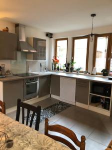 a kitchen with a table and chairs in a room at Maison 6 chambres in Beauvais