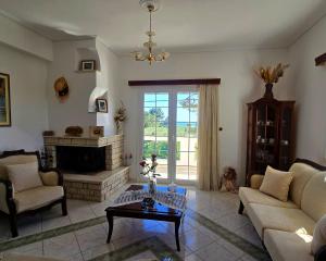 a living room with a couch and a fireplace at Annie's summer house in Plytra