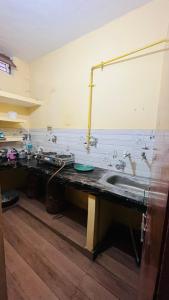 a kitchen with a sink and a counter top at Jaykishan sadan in Varanasi