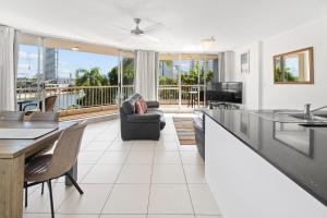 a living room with a couch and a table at Moorings On Cavill Surfers Paradise in Gold Coast