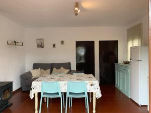 a dining room with a table and chairs and a couch at Casa rural Arroyo Marco in Guadalcanal