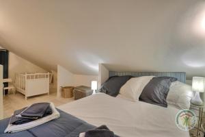 a bedroom with a large bed and a crib at Les petites landes in Pleumeleuc