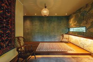 a room with a table and a chair and a rug at 森寧monet in Minami Aso