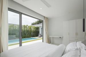 a bedroom with a white bed and a large window at Silk Villa - 3 Bedrooms - Pool - Central Area in Bophut +15 photos