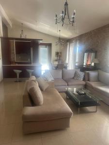 a living room with a couch and a table at Anna Apartments in Keramotí