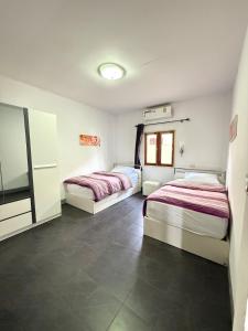two beds in a room with tile floors at Tropical 2 Bedroom Pool House In Central Location in Hua Hin +17 photos