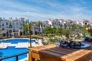 a man laying on a raft on a table next to a swimming pool at Casa Albatros - Poolside Retreat in Torre-Pacheco