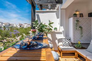 a wooden table with plates of food on a patio at Casa Albatros - Poolside Retreat in Torre-Pacheco