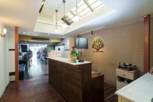a store lobby with a counter with flowers on it at Dancenter Khaosan Park Hotel in Bangkok