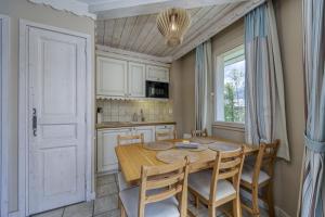 a kitchen with a table and chairs and a window at La Terrasse du Lac in Duingt