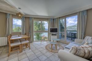 a living room with a couch and a table at La Terrasse du Lac in Duingt