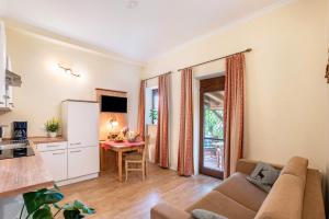 a living room with a couch and a table at Komfort Apartment Römersberger - 6 in Vogtareuth