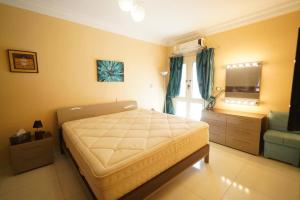 a bedroom with a large bed and a mirror at Agouza 150m Apartment, new first rent in Cairo