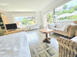 a living room with a bed and chairs and a tv at Apartment Rose in Forbach
