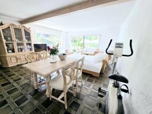 a dining room with a table and a couch at Apartment Rose in Forbach