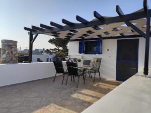 a patio with chairs and a table on a roof at DaGiorgio in Pitsiniánika