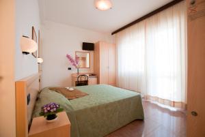 Postel nebo postele na pokoji v ubytování Hotel Jonni