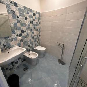 a bathroom with a sink and a toilet at Maison Emi in Montecorice
