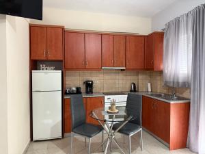 a kitchen with a small table and a refrigerator at Gerapetros 82 in Ierapetra