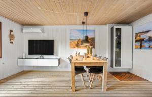 a dining room with a table and a sink at 2 Bedroom Lovely Home In Skagen in Skagen