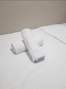 a roll of toilet paper sitting on top of a bed at Jardin B20, Pool View, Netflix & WIFI in Bandung +17 photos