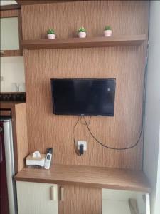 a tv on a wall in a room at Jardin B20, Pool View, Netflix & WIFI in Bandung