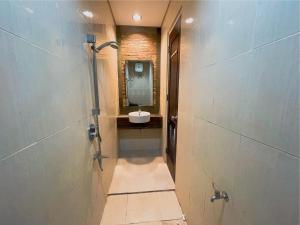 a bathroom with a sink and a mirror at Sighma Palem Merah Senopati in Jakarta