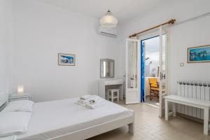 A bed or beds in a room at Apollon Rooms