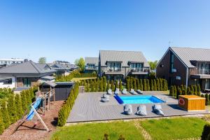 an aerial view of a house with a swimming pool at Ievara apartamentai in Palanga