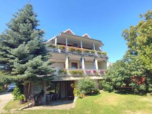 a large house with flowers on the balconies of it at Apartments in Balatonföldvar 45318 in Balatonföldvár