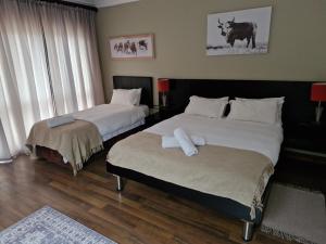 Postel nebo postele na pokoji v ubytování BergWood Inn