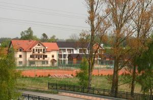 a large house with a fence in front of it at Pensjonat Elżbieta in Łeba