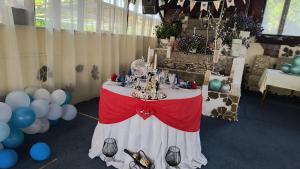 a table with a cake on top of it with balloons at Clubul Veteranilor in Viforîta