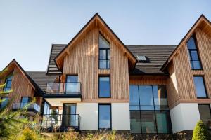 an exterior view of a house with wooden siding at Apartament JOA in Zakopane
