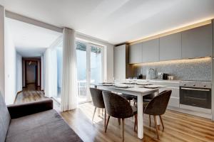 a kitchen with a white table and chairs in a room at Blue Hotel Oporto in Porto