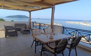 a table and chairs on a patio with a view of the ocean at Anna Maria - Vanessa Apartments in Neo Klima