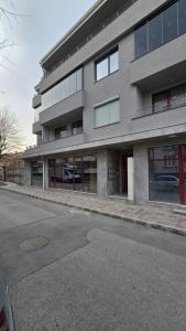 a large building with windows on the side of a street at Urban Retreat - Sliven City Center in Sliven